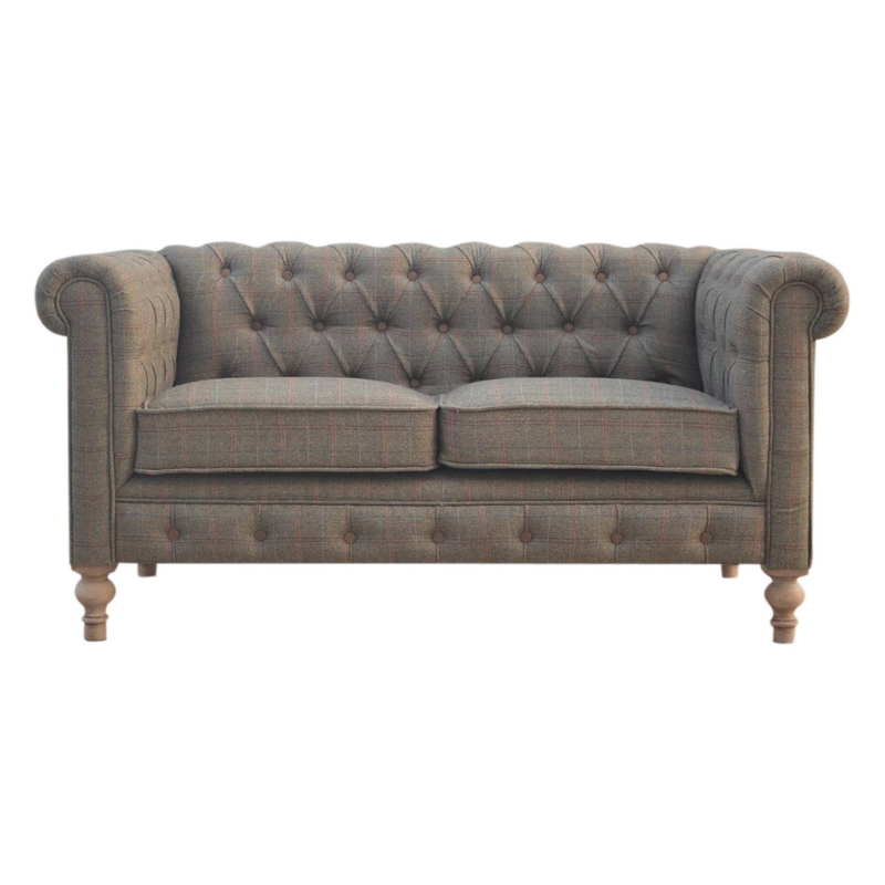 Gray tufted sofa on a white background