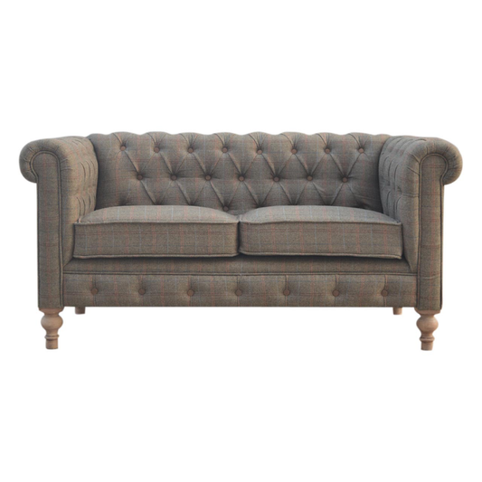 Gray tufted sofa on a white background