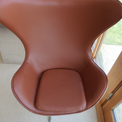 The Aviator Egg Chair in Black Real Leather and Aluminum is a stunning piece of furniture meticulously handcrafted to exude timeless elegance and exceptional comfort.