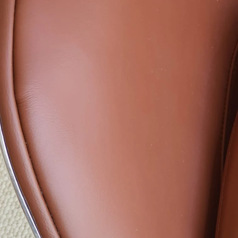 The Aviator Egg Chair in Black/Brown Real Leather and Aluminum is a stunning piece of furniture meticulously handcrafted to exude timeless elegance and exceptional comfort.
