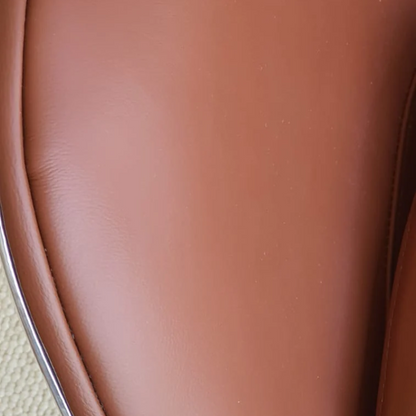 The Aviator Egg Chair in Black/Brown Real Leather and Aluminum is a stunning piece of furniture meticulously handcrafted to exude timeless elegance and exceptional comfort.
