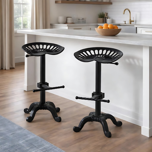 Two black adjustable stools in a kitchen setting with a white island.