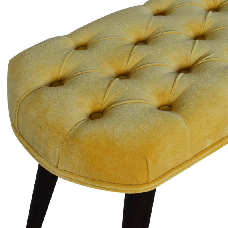 This Nordic style bench has been upholstered in a beautiful Mustard yellow cotton velvet fabric and features a classy deep-button design on the top.  The bench stands on 4 legs constructed from 100% solid mango wood in a walnut finish and it is the perfect piece to add to your bedroom or hallway as a finishing touch in the home.