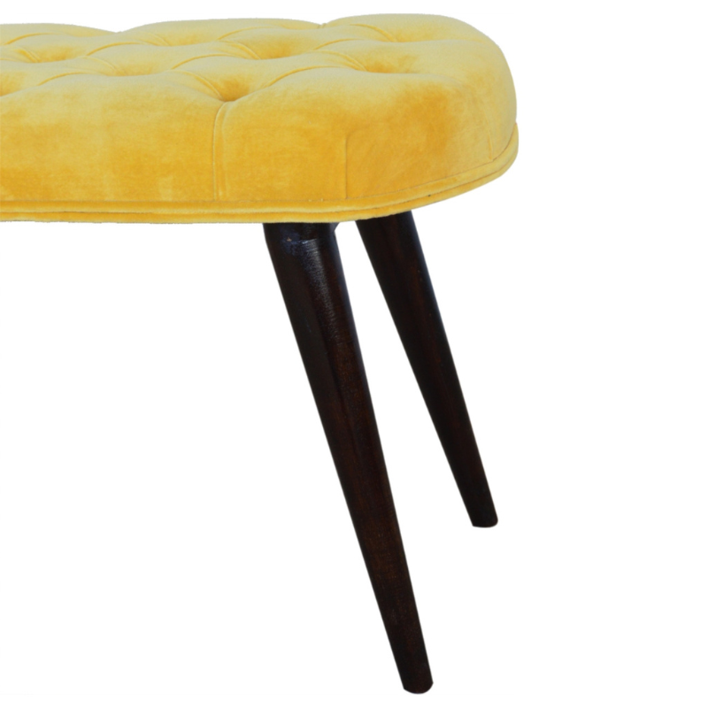 This Nordic style bench has been upholstered in a beautiful Mustard yellow cotton velvet fabric and features a classy deep-button design on the top.  The bench stands on 4 legs constructed from 100% solid mango wood in a walnut finish and it is the perfect piece to add to your bedroom or hallway as a finishing touch in the home.