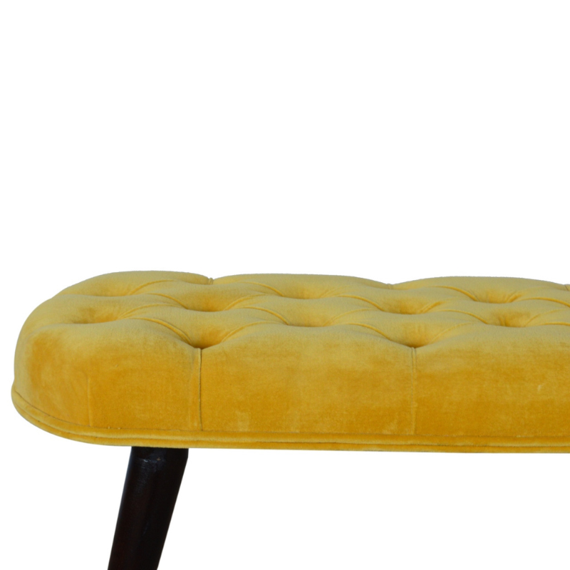 This Nordic style bench has been upholstered in a beautiful Mustard yellow cotton velvet fabric and features a classy deep-button design on the top.  The bench stands on 4 legs constructed from 100% solid mango wood in a walnut finish and it is the perfect piece to add to your bedroom or hallway as a finishing touch in the home.