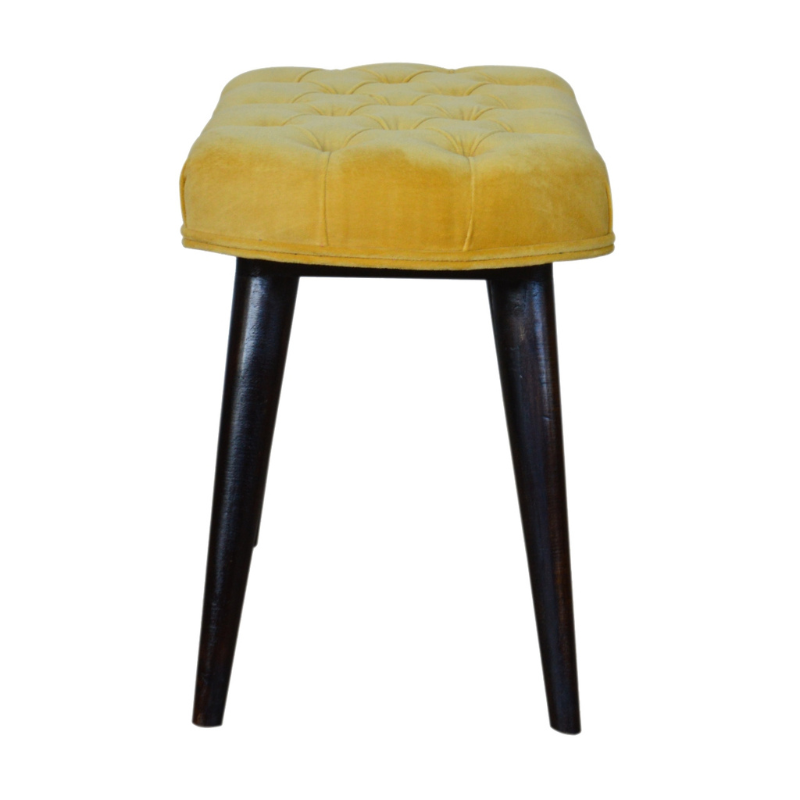 This Nordic style bench has been upholstered in a beautiful Mustard yellow cotton velvet fabric and features a classy deep-button design on the top.  The bench stands on 4 legs constructed from 100% solid mango wood in a walnut finish and it is the perfect piece to add to your bedroom or hallway as a finishing touch in the home.