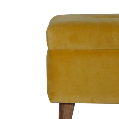 This little footstool is a elegant addition to the home. It has been upholstered in a mustard yellow cotton velvet fabric and has 4 solid wood nordic wood style legs in an oak-ish finish.  It is beautiful and versatile at the same time, it has an important feature which is the storage compartment that can be used to place things inside and save space in the home.