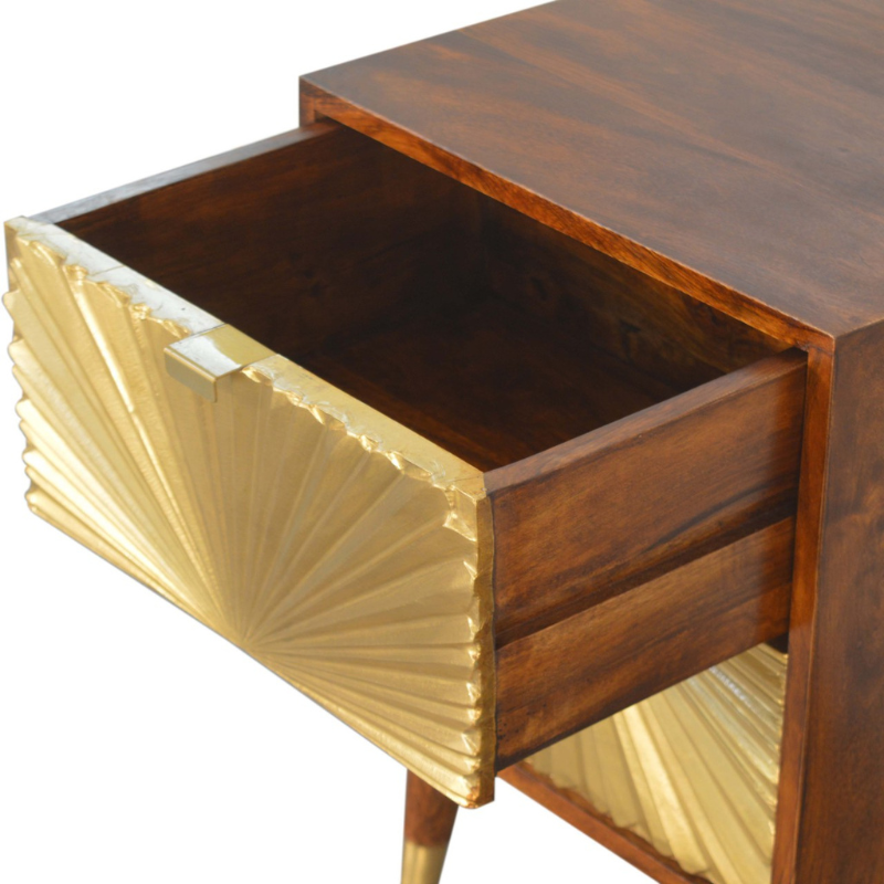 This Manila Gold Chestnut Bedside Table was designed to add a touch of elegance and charm to your bedroom. Featuring brass-plated drawers and Nordic-style brass cap feet, this piece has been constructed from 100% solid mango wood and offers a rich chestnut finish along with pull-out handles and surface space to uplift your whole bedroom look.