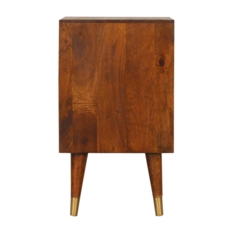 This Manila Gold Chestnut Bedside Table was designed to add a touch of elegance and charm to your bedroom. Featuring brass-plated drawers and Nordic-style brass cap feet, this piece has been constructed from 100% solid mango wood and offers a rich chestnut finish along with pull-out handles and surface space to uplift your whole bedroom look.