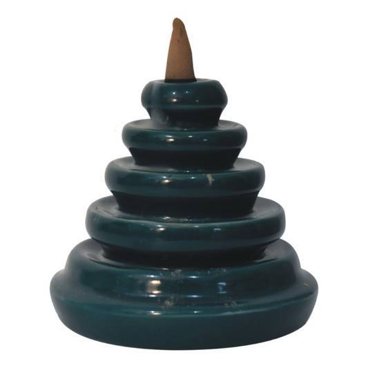 The backflow fountain burner set is exquisitely crafted and features a unique teal waterfall design, ideal as a gift for friends and family. The set includes a backflow burner, incense holder, fragrant backflow cones in Rose, Lavender, Jasmine and Pineapple and fragrant inscense sticks in Amber, Lavender, Oudh and Woods.