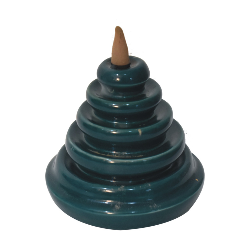 The backflow fountain burner set is exquisitely crafted and features a unique teal waterfall design, ideal as a gift for friends and family. The set includes a backflow burner, incense holder, fragrant backflow cones in Rose, Lavender, Jasmine and Pineapple and fragrant inscense sticks in Amber, Lavender, Oudh and Woods.