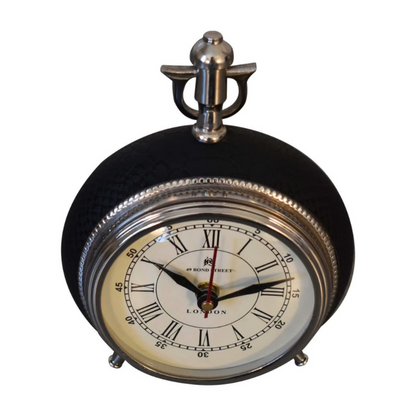 This handsome alarm clock is inspired by Art Deco design with its large numerals, metal bezel and matching hands, and housed in a convex glass lens. Display this piece beautifully on your bedside.