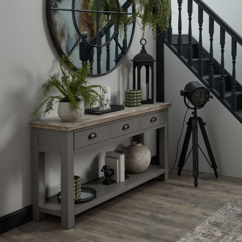 The Oxley Collection Three Drawer Console Table is perfect for display as well as storage. A washed wood plank surface blended with a frame in a warm grey hue deliver a relaxed, informal feel to any space. Stylish as well as functional, this high quality item would be equally at home in traditional and contemporary styled spaces.