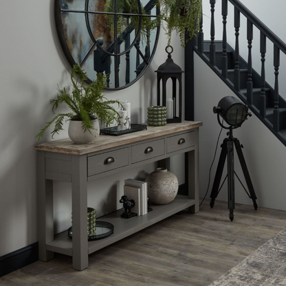 The Oxley Collection Three Drawer Console Table is perfect for display as well as storage. A washed wood plank surface blended with a frame in a warm grey hue deliver a relaxed, informal feel to any space. Stylish as well as functional, this high quality item would be equally at home in traditional and contemporary styled spaces.