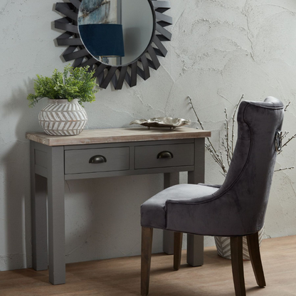 The Oxley Collection Two Drawer Console Table is perfect for display as well as storage. A washed wood plank surface blended with a body in a warm grey hue deliver a relaxed, informal feel to any space. Stylish as well as functional, this high quality item would be equally at home in traditional and contemporary styled spaces. Style with a large mirror or art piece above to really highlight its beauty. Perfect for a hallway but could also be put to use in the bedroom as a dressing table.