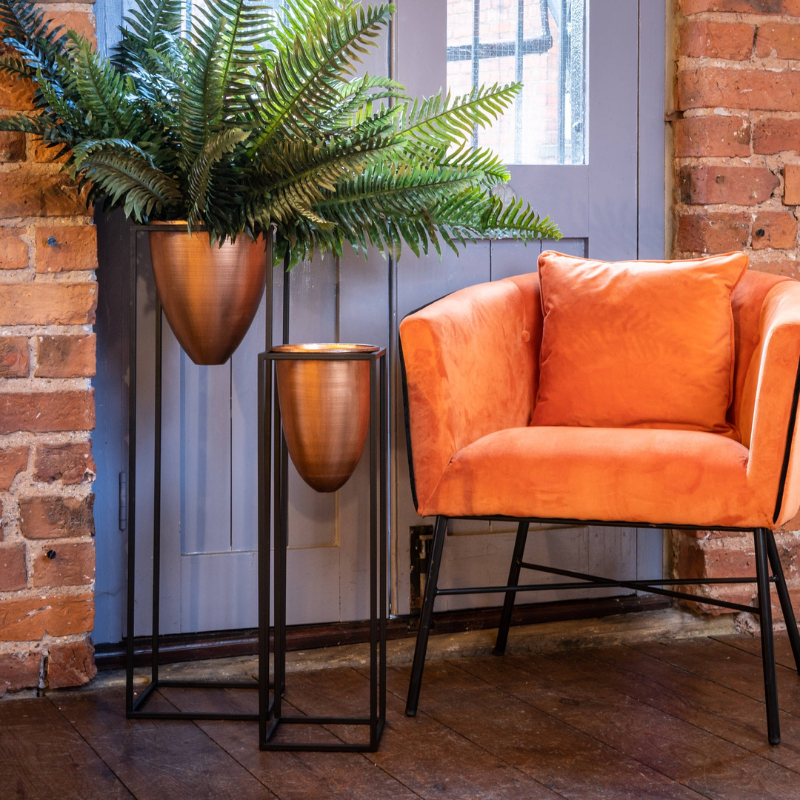 This is the Large Copper Bullet Planter On Black Frame, a unique and contemporary planter in style and features which is sure to bring an element of design and class into any interior.