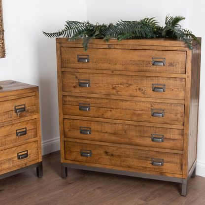 The combination of raw and organic textures of a solid pine body and cast iron accents has been used in the Draftsman Collection. This is the Draftsman Collection Five Drawer Chest which is 120cm high, 110cm wide and 42cm deep with 5 spacious drawers making it a handsome storage addition.