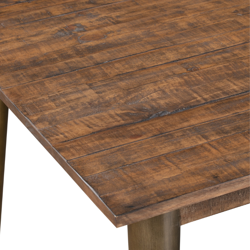 This is the Havana Gold Dining Table. This table's warm, dark stained pine top combined with the antique gold finish to the legs delivers a modern and sophisticated feel to a room. The rough sawn pine planks used to create this tables surface give it great texture and distinctiveness. This item is perfect for anyone wishing to create a stylish yet cosy dining space.