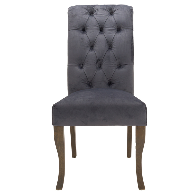 This is the Knightsbridge Roll Top Dining Chair. A sumptuous button pressed velvet chair in a timeless great colour with roll-top detail and silver ring pull that will add elegance and class to a variety of interiors. Built from a rubberwood frame, known for its dense grain and strength, it is a sturdy piece, ready for everyday use. All upholstered items have passed UK fire safety regulations with cigarette and match test certificates.