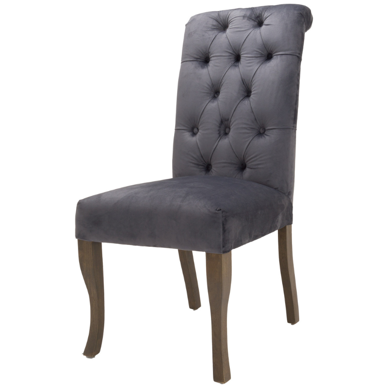 This is the Knightsbridge Roll Top Dining Chair. A sumptuous button pressed velvet chair in a timeless great colour with roll-top detail and silver ring pull that will add elegance and class to a variety of interiors. Built from a rubberwood frame, known for its dense grain and strength, it is a sturdy piece, ready for everyday use. All upholstered items have passed UK fire safety regulations with cigarette and match test certificates.