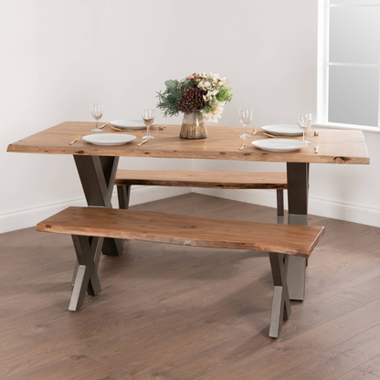 The Live Edge Collection Dining Table is made from Indian acacia wood creating charm and character, this range helps you to bring a feel of the outdoors in by creating a minimal and earthy look. The simplicity of these designs are what makes them so impressive, each piece is complete with a grey metal cross leg design or frame which complements the rustic and natural design of the wood.