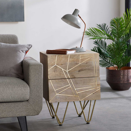 This beautiful side table offers 2 spacious drawers and is complemented with gold metal legs, featuring metal inlays on the fronts of the drawers.  This range is offered in a light natural finish Drawer dimensions (HxWxD): 12.5x37x30 cm