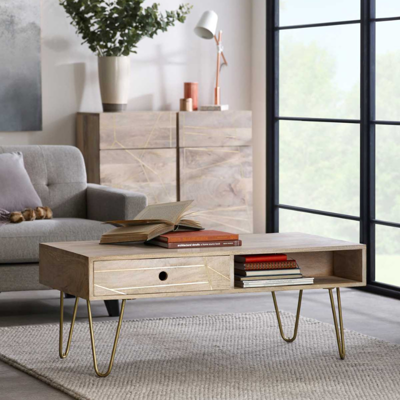 This rectangular coffee table comes with one shelf and 1 drawer on each side of the unit, offering ample storage space. This range is offered in a light natural finish, featuring gold metal inlays on drawers fronts.  Drawer dimensions (HxWxD): 9.5x48x28 cm Shelf dimensions (HxWxD): 9.5x52x24 cm