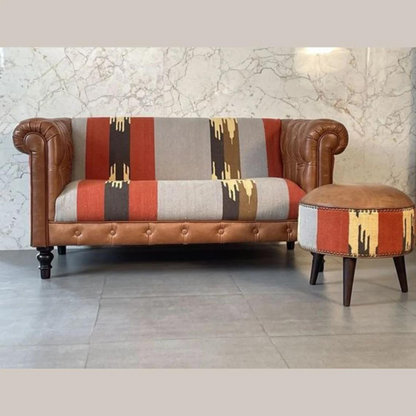 Introduce a playful piece to your interiors with this mixed footstool.  Combining both buffalo leather and durrie prints, it has nordic style legs in a dark walnut finish and it is the perfect piece to use in the living room with its compact size, making it ideal for extra seating for guests or as a footrest.