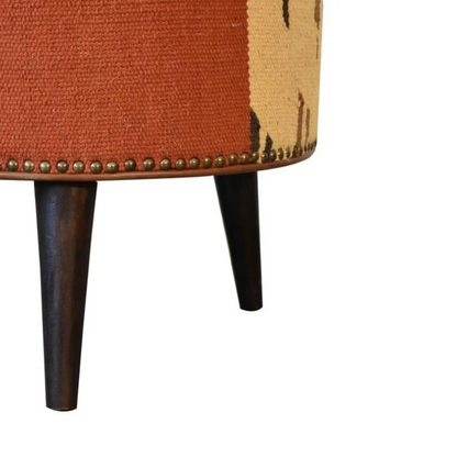 Introduce a playful piece to your interiors with this mixed footstool.  Combining both buffalo leather and durrie prints, it has nordic style legs in a dark walnut finish and it is the perfect piece to use in the living room with its compact size, making it ideal for extra seating for guests or as a footrest.