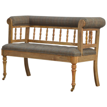 Add some luxury style to your home living area with this fabulous country tweed hallway bench. It is constructed from 100% solid mango wood in a oak-ish finish and upholstered in 100% multi tweed.  Other features include antique studs, detailed hand carved and hand turned front legs with casters and an overall oak-ish finish.