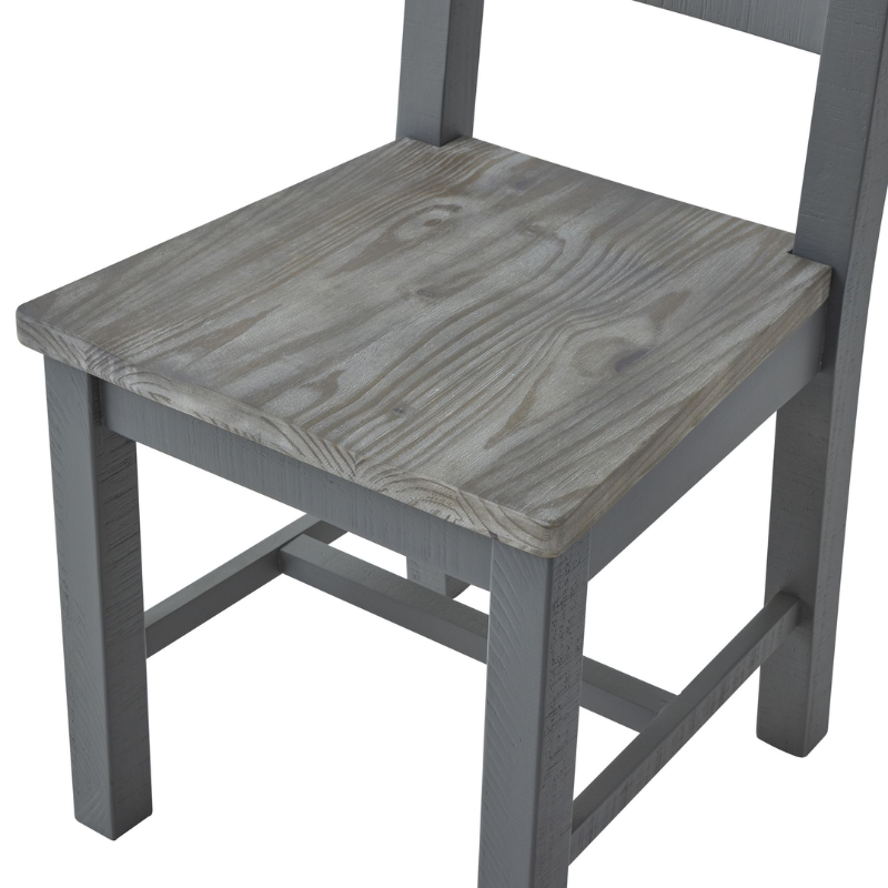 The chair's minimal design makes it a versatile addition to any dining area, whether traditional or modern. This dining chair can be paired with the matching table from the same collection to create a cohesive look in your dining space. The Oxley Collection is crafted from rough-sawn pine planks, giving each piece its unique character and worn vibe. The black cup handles add a contemporary touch to the design, while the washed pine top brings the whole look together.