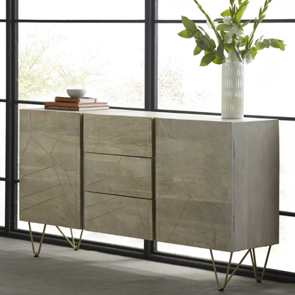 Extra Large Sideboard, featuring 3 drawers in the centre of the unit and 1 door on each side, with one interior shelf behind each door.  The perfect addition to your dining room, providing a very ample storage space. This range is offered in a light natural finish, complemented with gold metal inlays on the front of the unit.