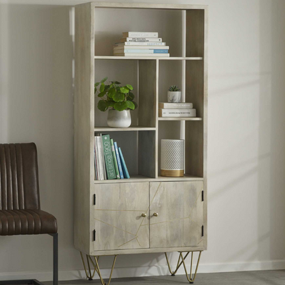 This stylish bookcase features a versatile storage space, designed with a cabinet at the bottom of the unit and 5 open shelves that can be used for books, magazines etc.  This range is offered in a light natural finish, complemented with gold metal inlays on the front of the unit.