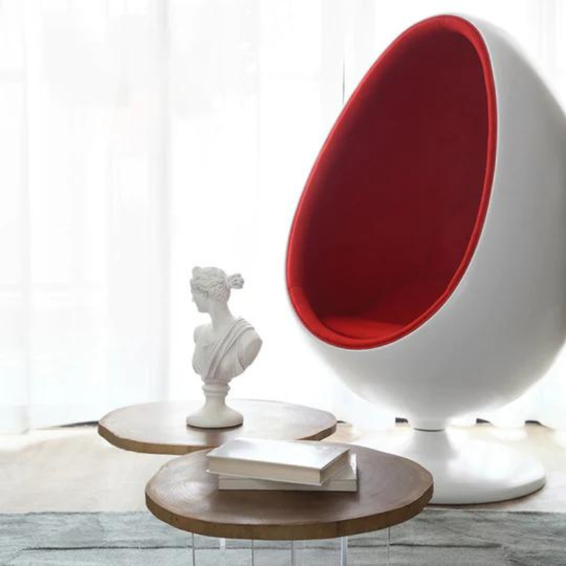 The Egg Pod Chair-Red Interior is a high-quality, retro-style chair that offers comfort and intimacy. Made of durable fiber glass material, it has a unique and unconventional design that has remained fashionable for decades. The chair features a swivel stand and a contoured seat upholstered with velvet or leather for a cozy atmosphere.