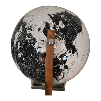 The wooden framed globe boasts a lovely white and black glossy finish. The spherical globe features loose engravings, depicting the world map. The relaxed nature and style of the design creates a striking contrast with the chrome frame.  This product is handcrafted individually and as every piece is unique please do expect variations in finish, texture, size and should not be considered as a defect.